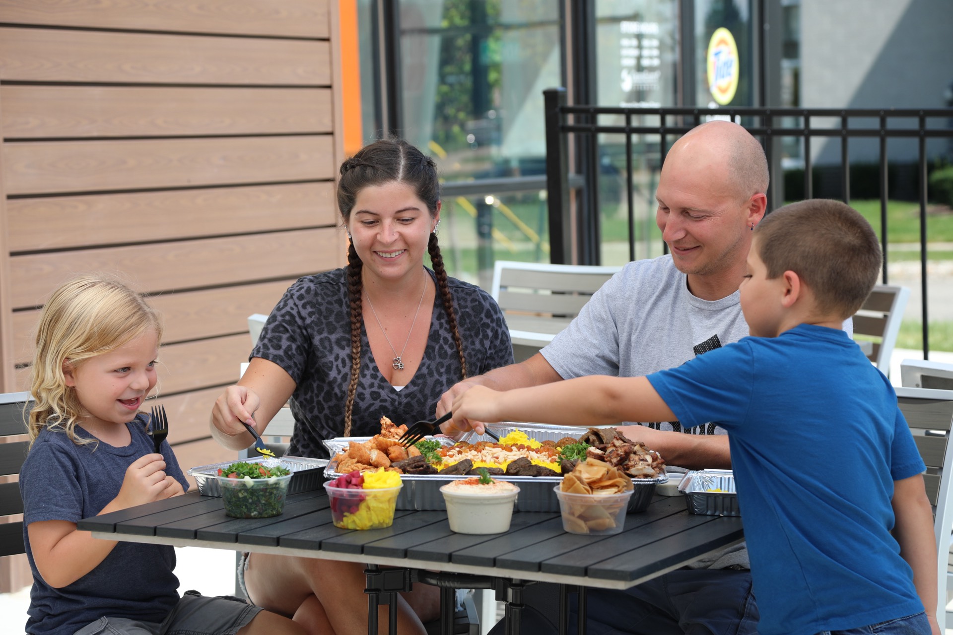 Family enjoying a meal at Pita Way
